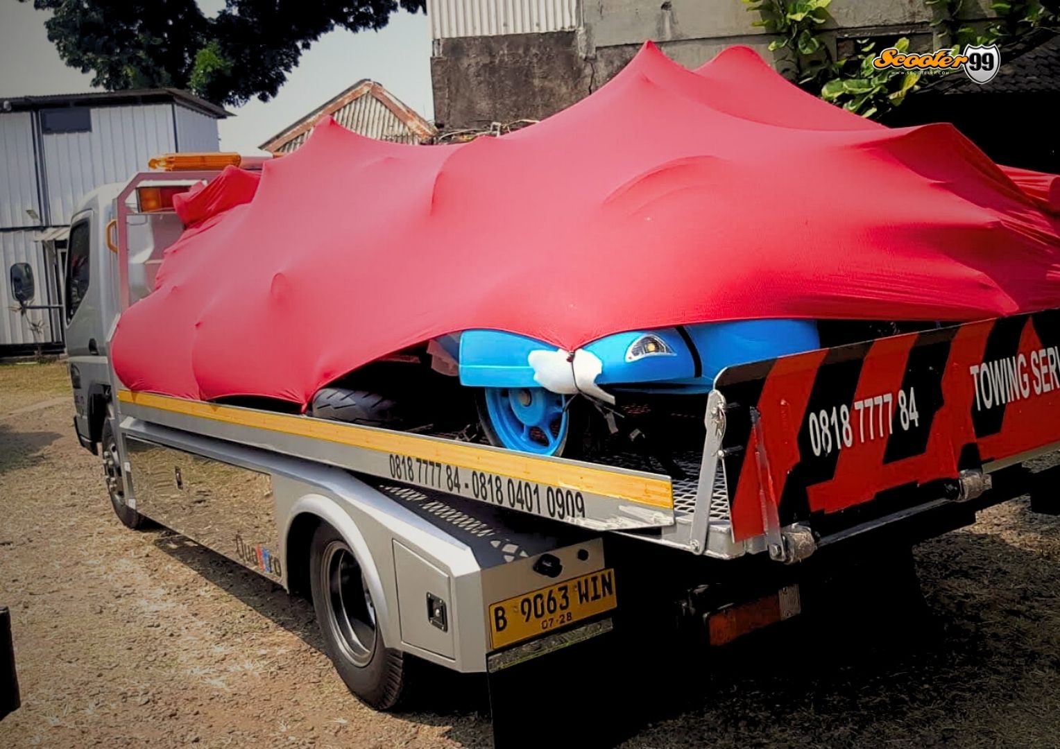 Towing truck in action, securing a vehicle on the roadside